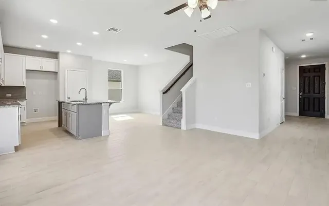 a view of a kitchen with furniture and a ceiling fan
