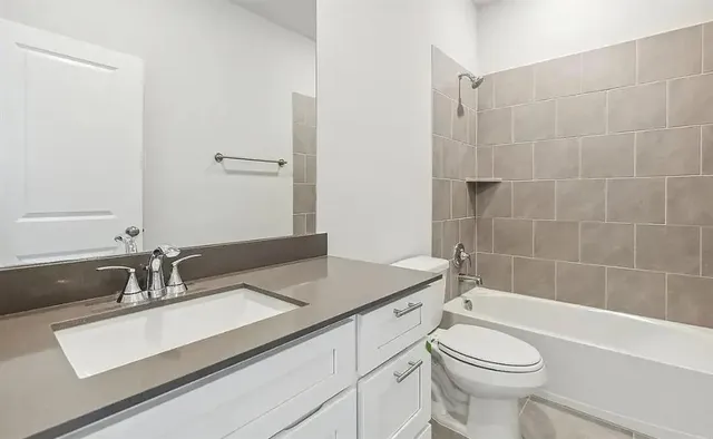 a bathroom with a sink a toilet and bathtub