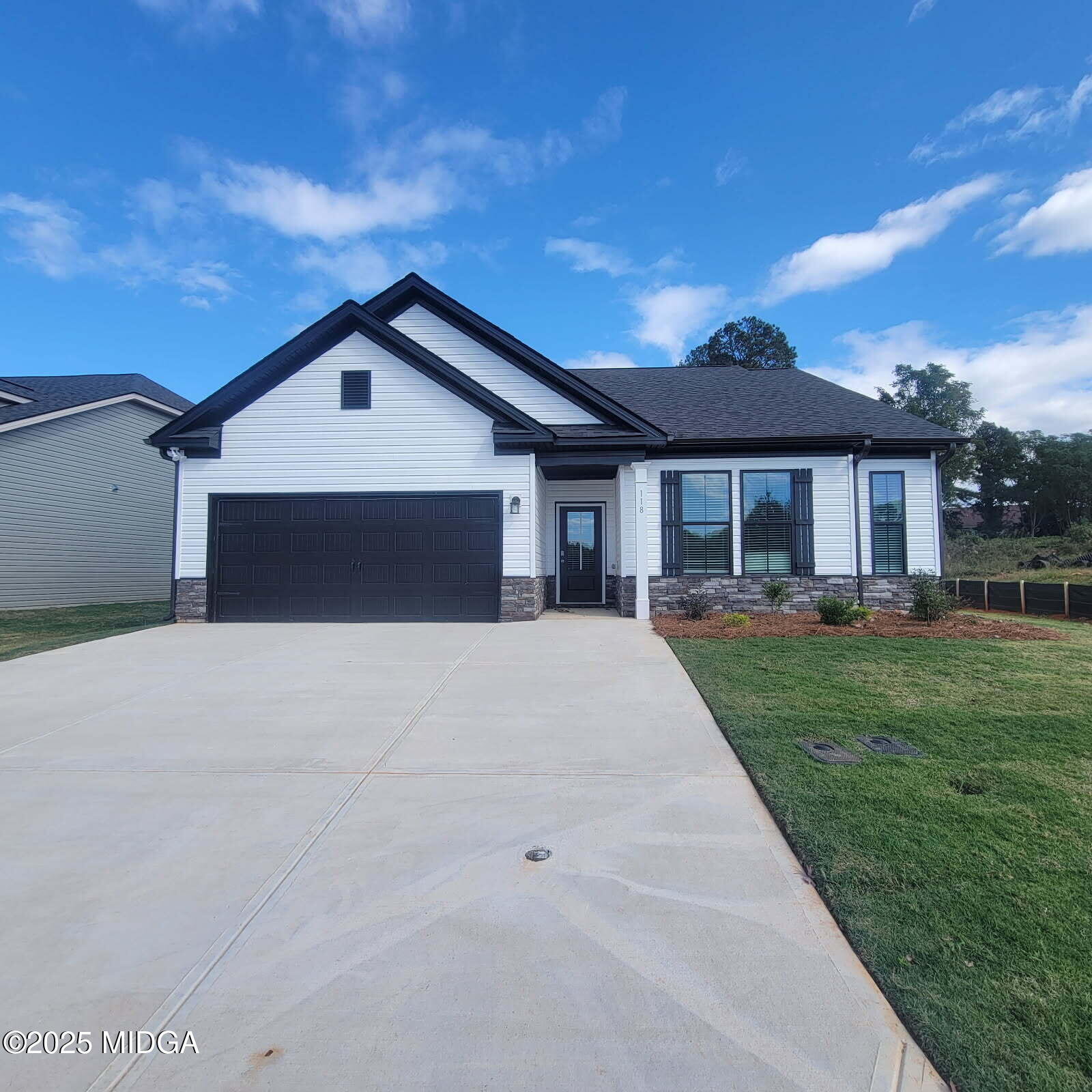 118 Bramblewood Way Perry, GA 31069 - Photo 1 of 27 a front view of a house with a yard and garage