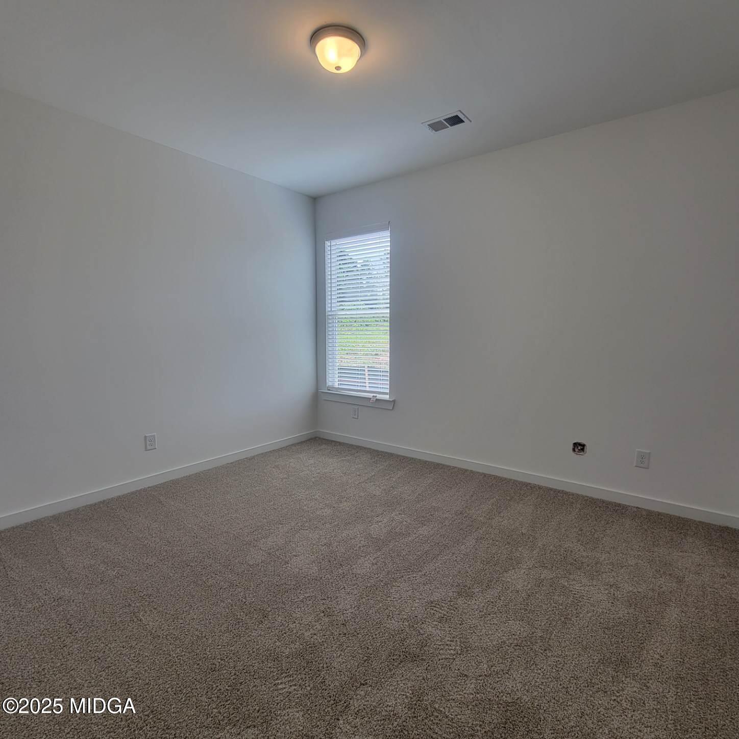 118 Bramblewood Way Perry, GA 31069 - Photo 12 of 27 a view of an empty room with a window