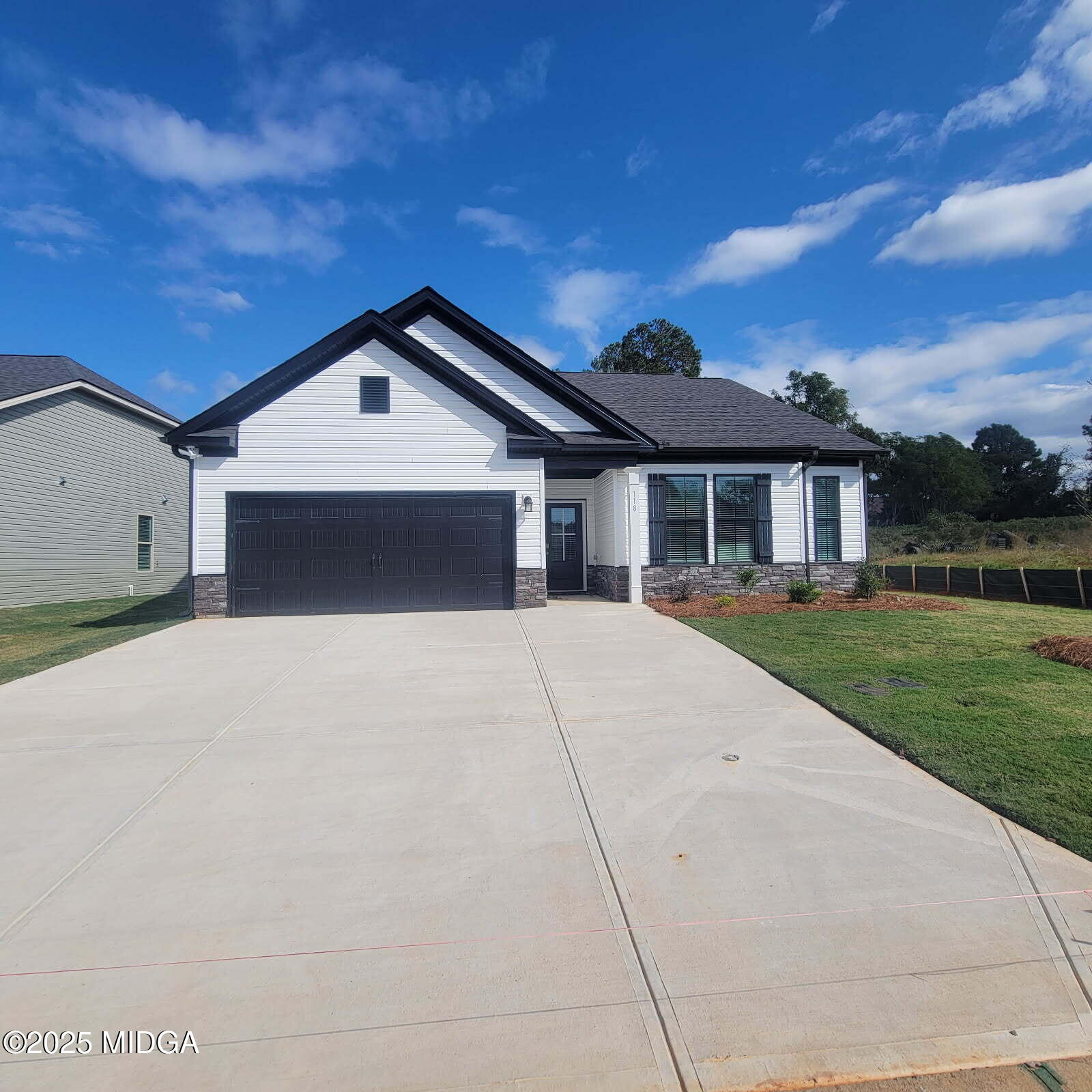 118 Bramblewood Way Perry, GA 31069 - Photo 2 of 27 a front view of a house with a yard