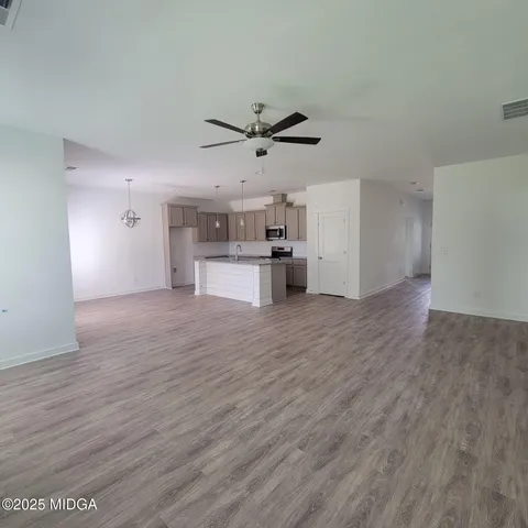 a view of a kitchen with a sink and a refrigerator