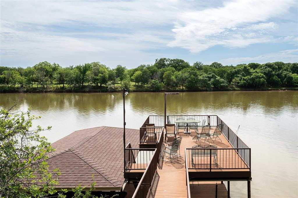 2312 Cactus Rio Lane Weatherford, TX 76087 - Photo 16 of 37 a view of a lake with a bench next to a lake