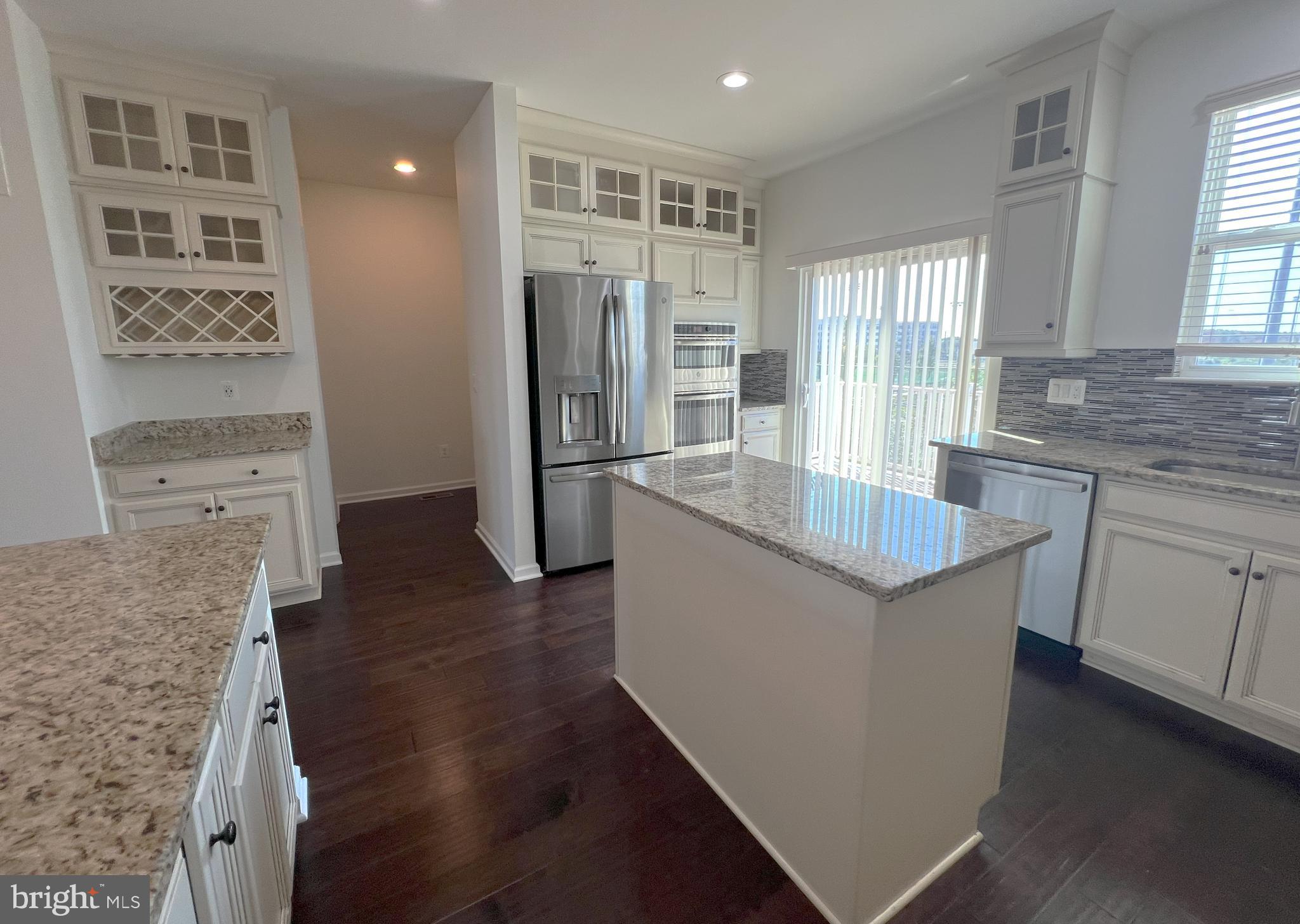 3092 Alan Shepard Street Herndon, VA 20171 - Photo 13 of 45 a kitchen with stainless steel appliances granite countertop a sink stove and refrigerator