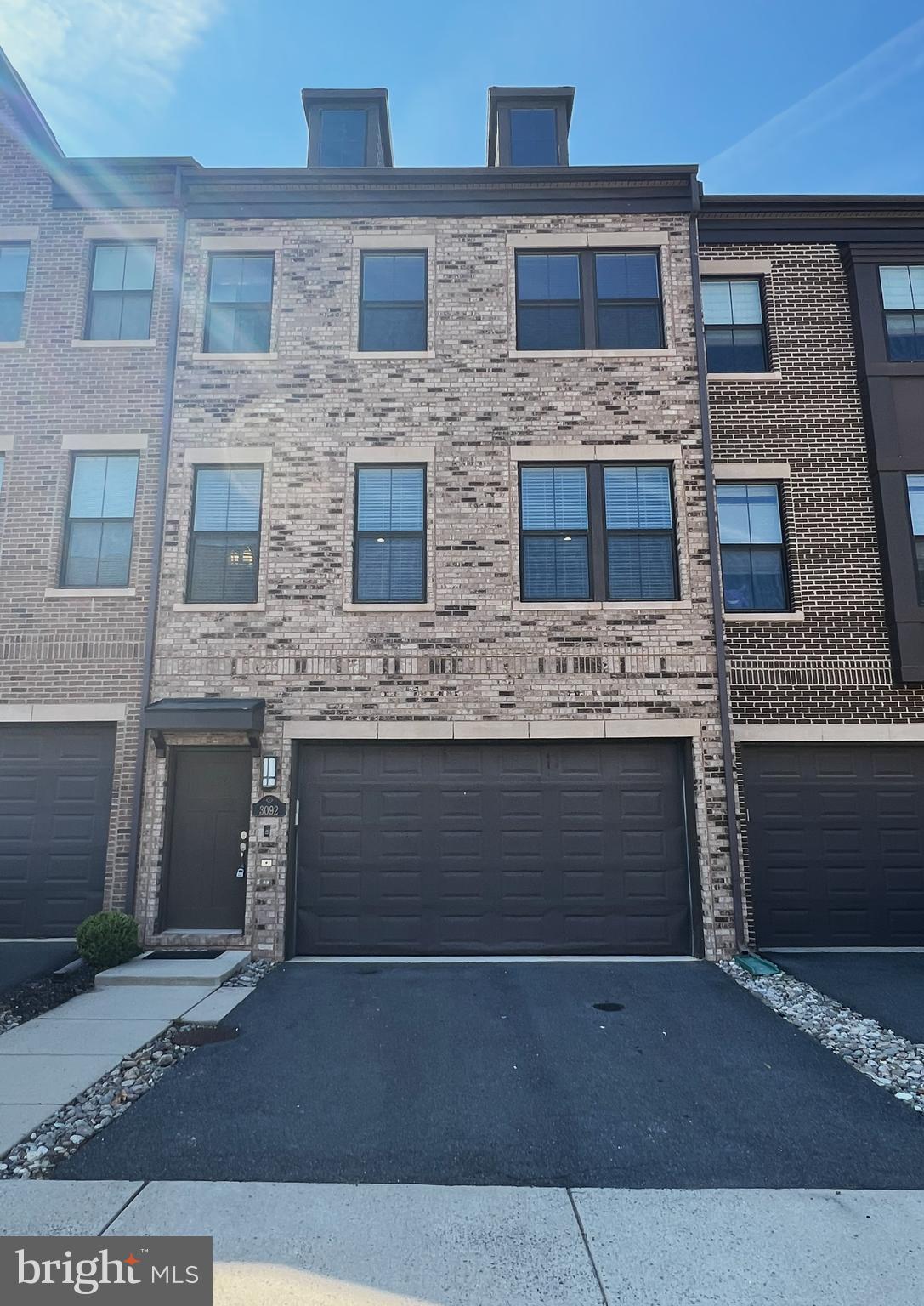 3092 Alan Shepard Street Herndon, VA 20171 - Photo 2 of 45 a front view of a building with a garage