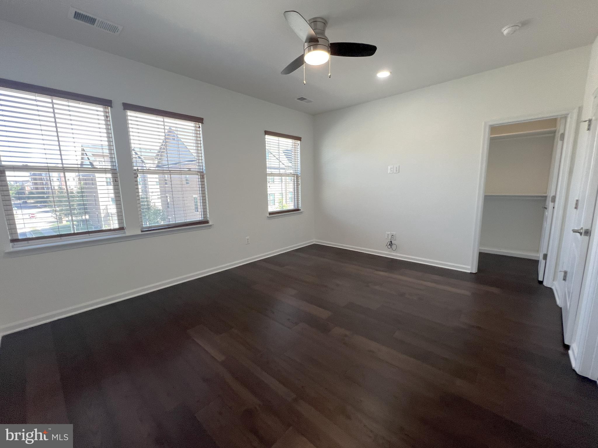 3092 Alan Shepard Street Herndon, VA 20171 - Photo 20 of 45 an empty room with wooden floor and windows