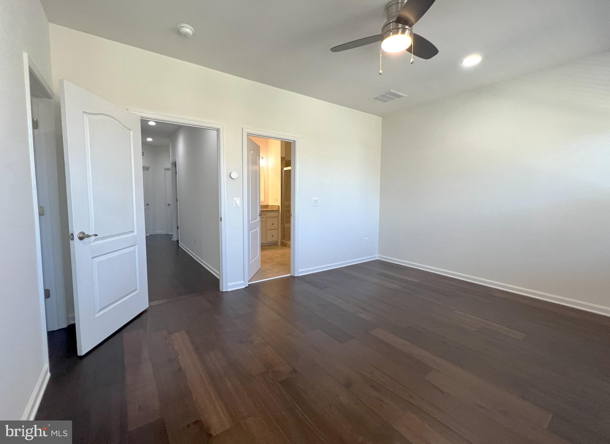 3092 Alan Shepard Street Herndon, VA 20171 - Photo 21 of 45 an empty room with wooden floor and ceiling fan
