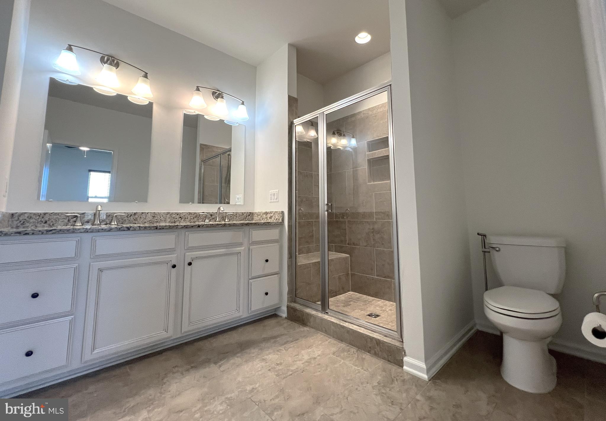 3092 Alan Shepard Street Herndon, VA 20171 - Photo 22 of 45 a bathroom with a granite countertop sink toilet and shower
