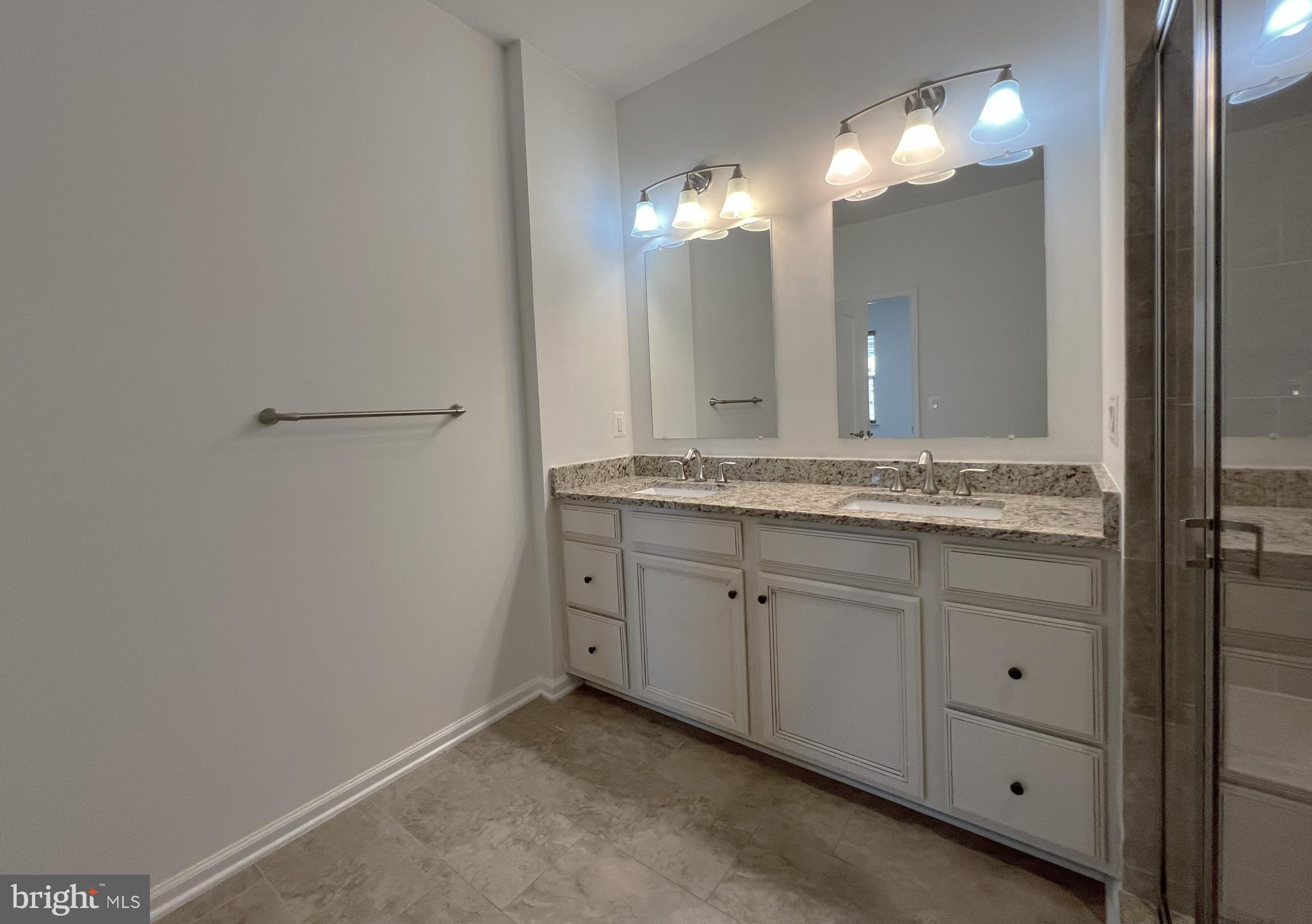 3092 Alan Shepard Street Herndon, VA 20171 - Photo 23 of 45 a bathroom with a sink and a mirror