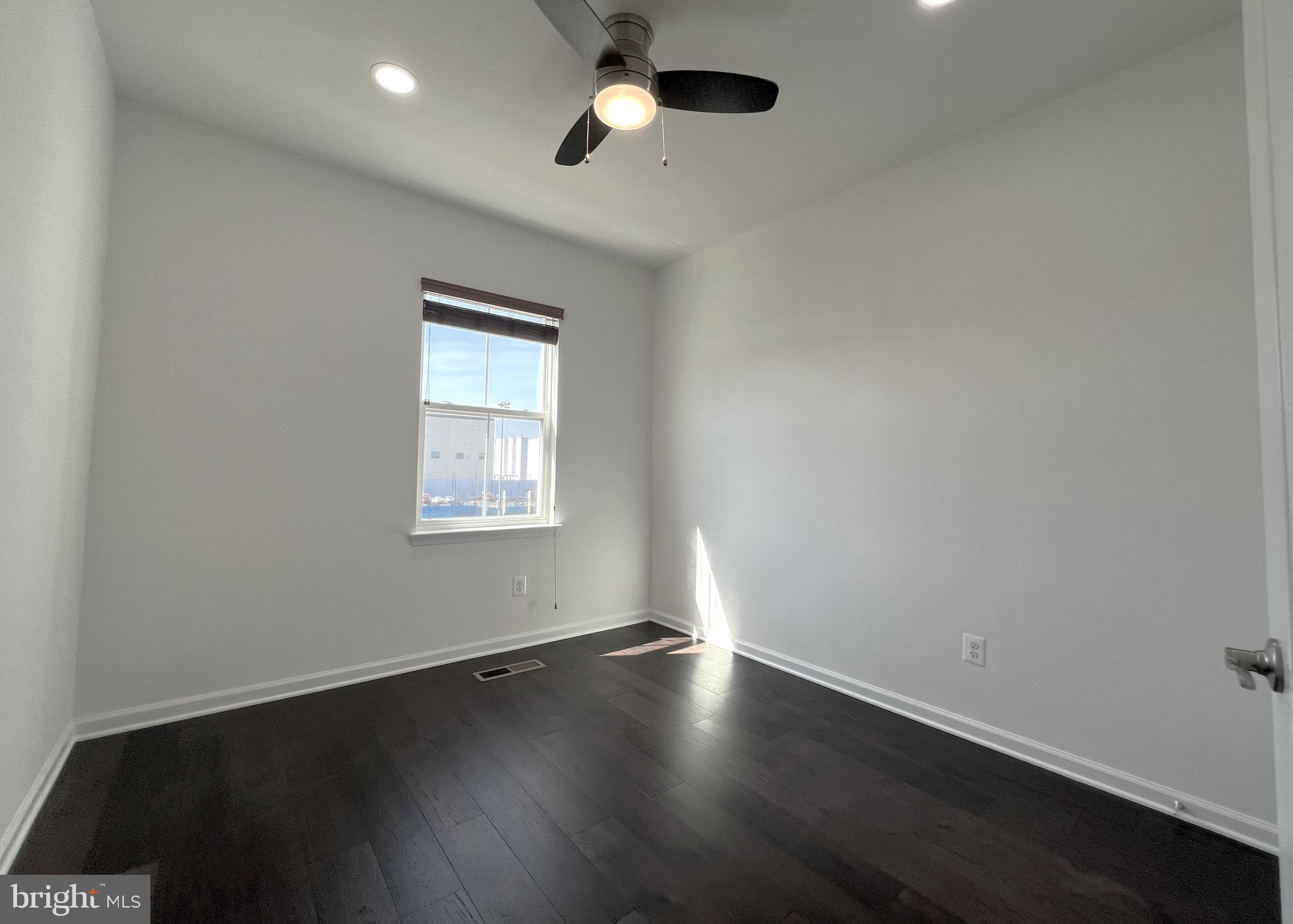 3092 Alan Shepard Street Herndon, VA 20171 - Photo 25 of 45 an empty room with wooden floor and windows
