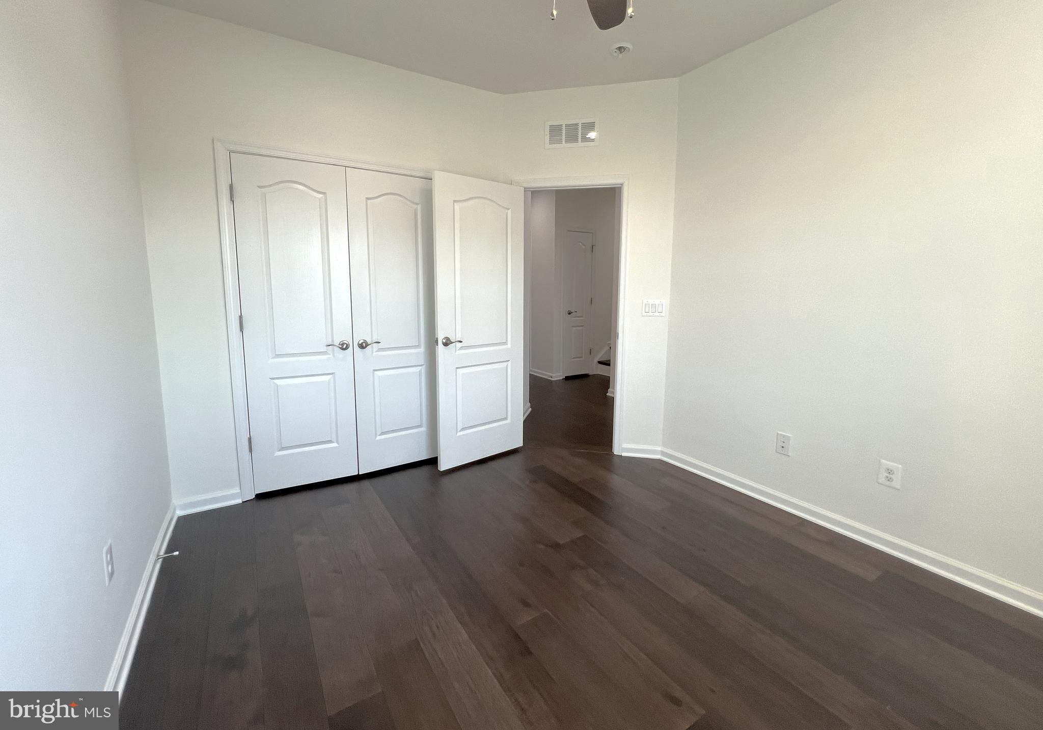 3092 Alan Shepard Street Herndon, VA 20171 - Photo 26 of 45 a view of an empty room with wooden floor