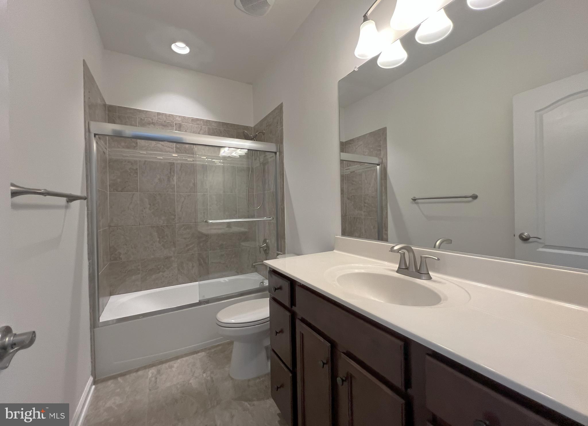 3092 Alan Shepard Street Herndon, VA 20171 - Photo 27 of 45 a bathroom with a sink a toilet and shower