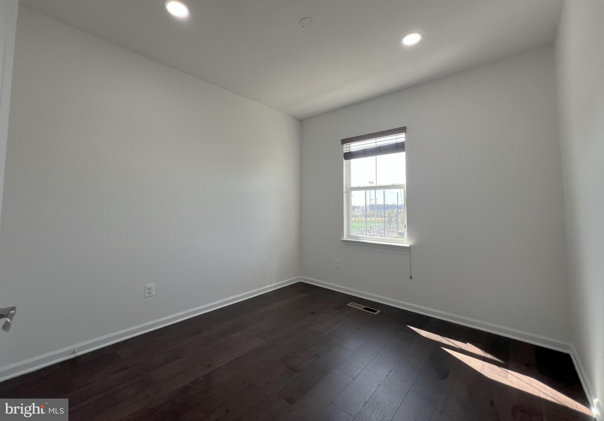 3092 Alan Shepard Street Herndon, VA 20171 - Photo 28 of 45 an empty room with wooden floor and windows