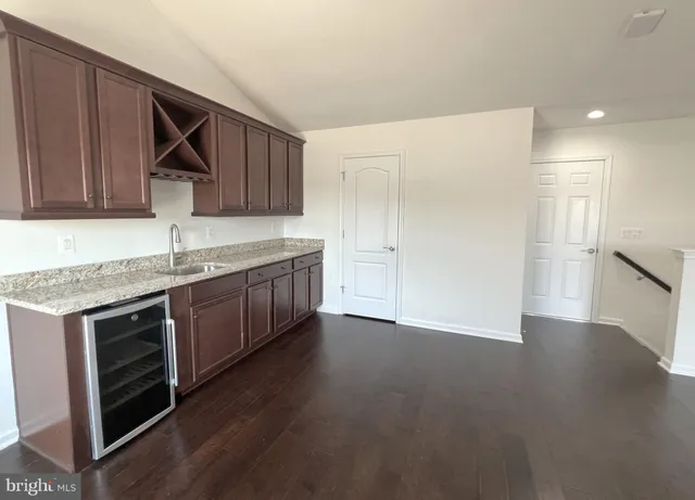 a kitchen with stainless steel appliances granite countertop a sink and a stove top oven