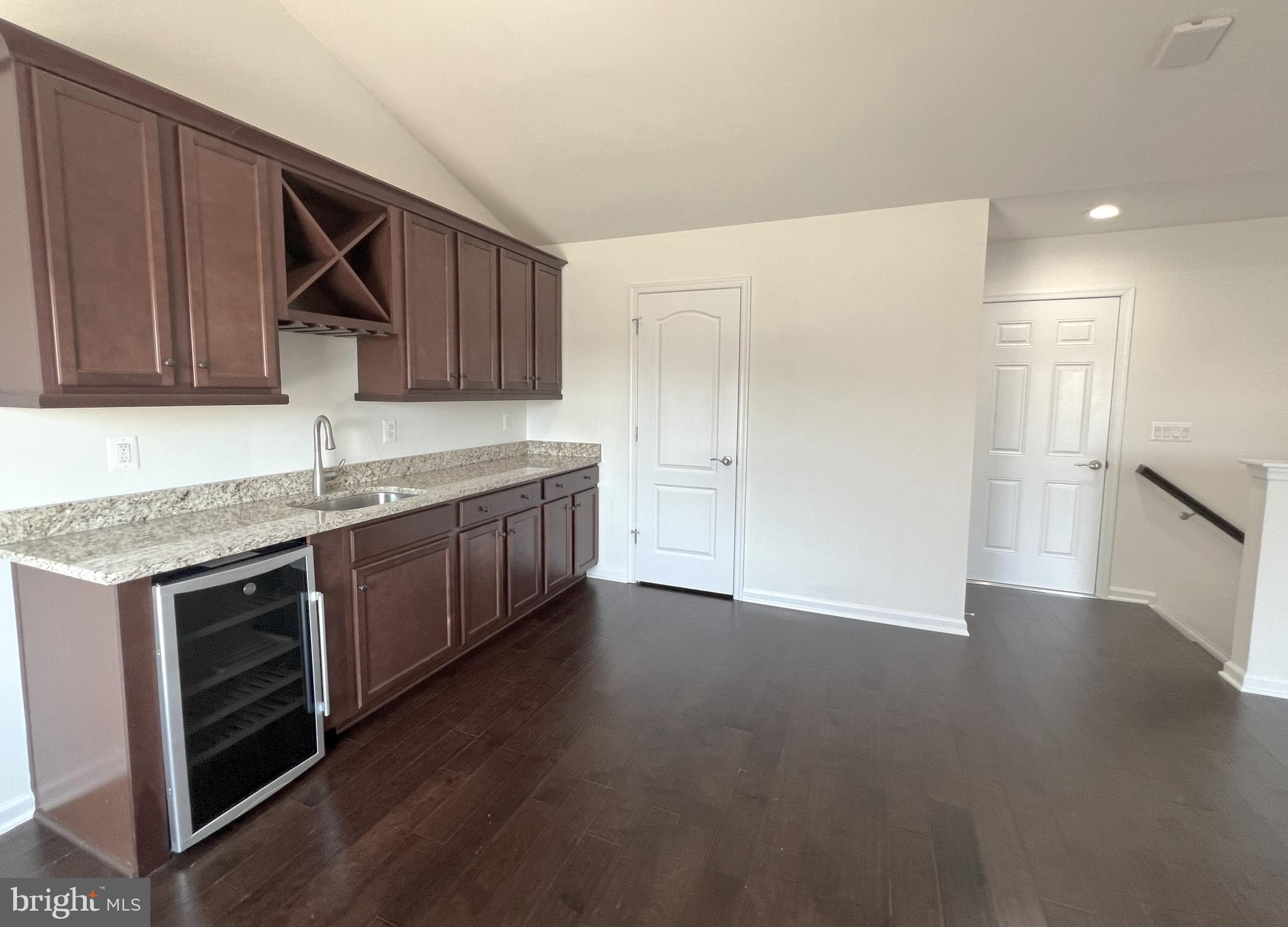 3092 Alan Shepard Street Herndon, VA 20171 - Photo 33 of 45 a kitchen with stainless steel appliances granite countertop a sink and a stove top oven