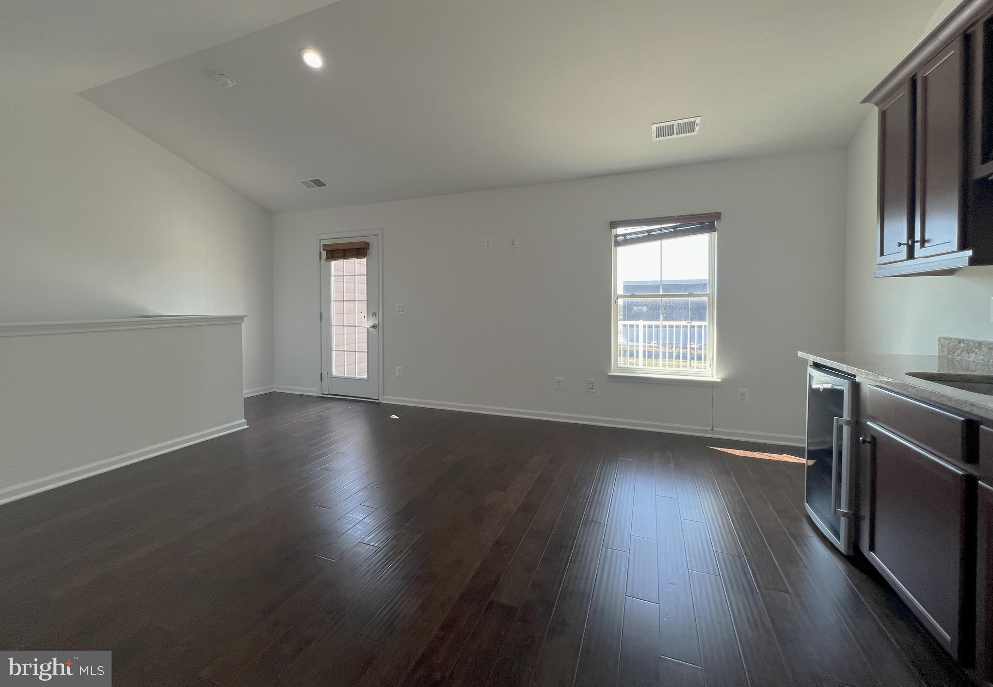 3092 Alan Shepard Street Herndon, VA 20171 - Photo 34 of 45 an empty room with wooden floors and windows