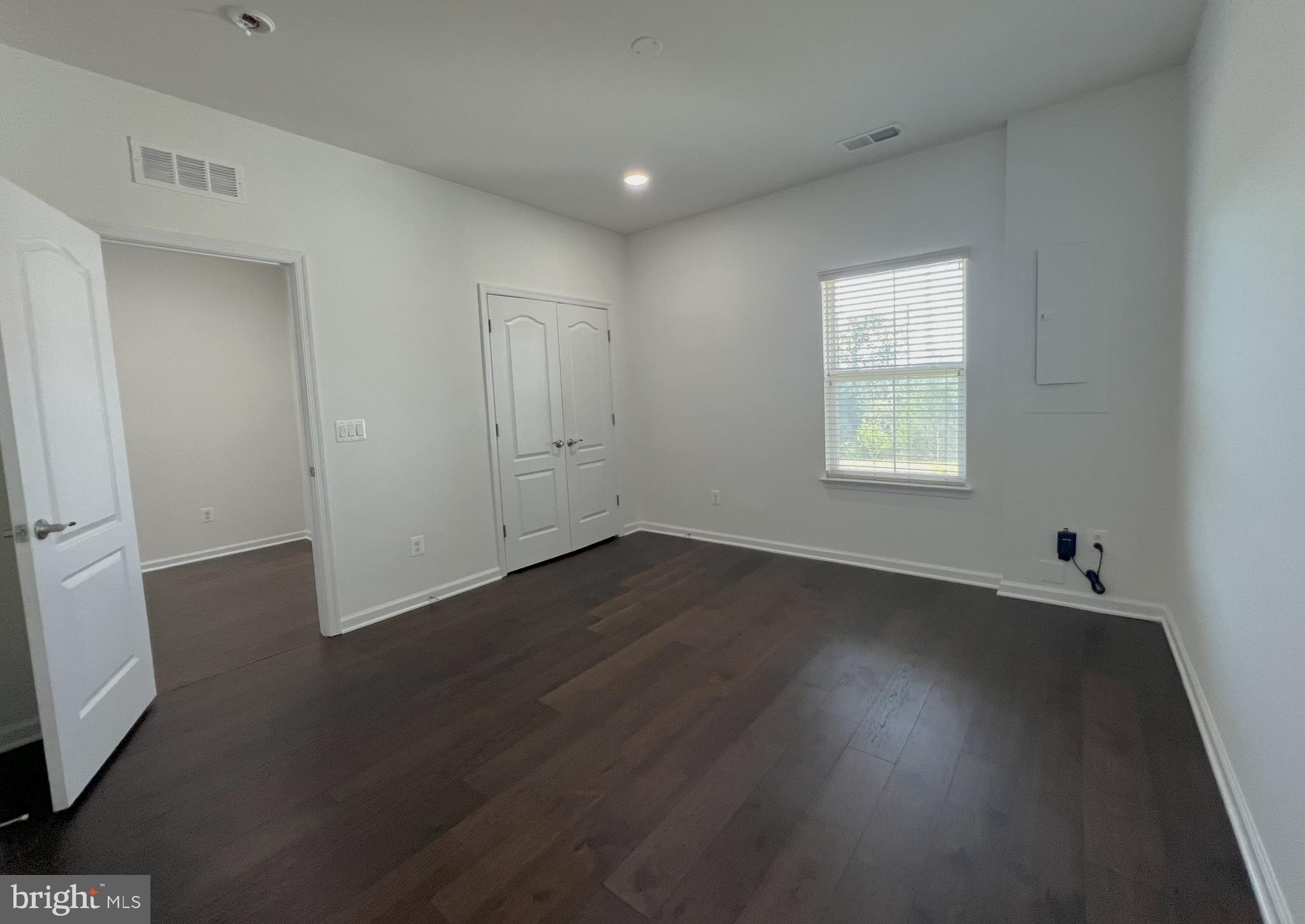 3092 Alan Shepard Street Herndon, VA 20171 - Photo 39 of 45 an empty room with wooden floor and windows