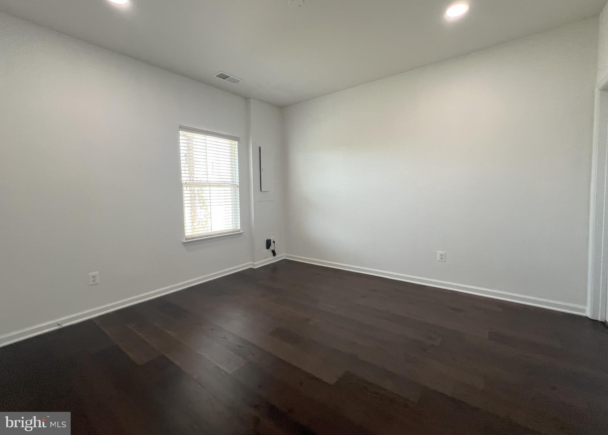 3092 Alan Shepard Street Herndon, VA 20171 - Photo 40 of 45 an empty room with wooden floor and windows
