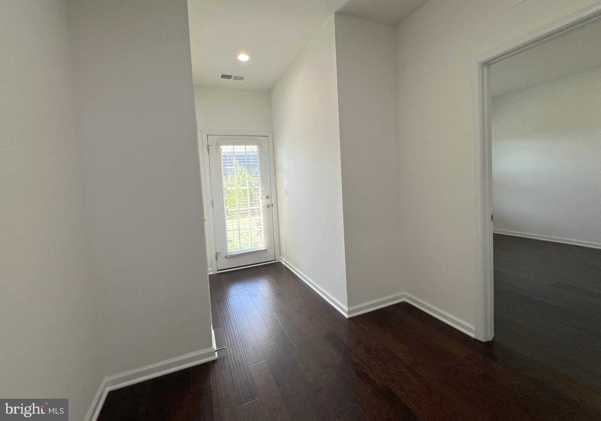 3092 Alan Shepard Street Herndon, VA 20171 - Photo 42 of 45 an empty room with wooden floor and windows