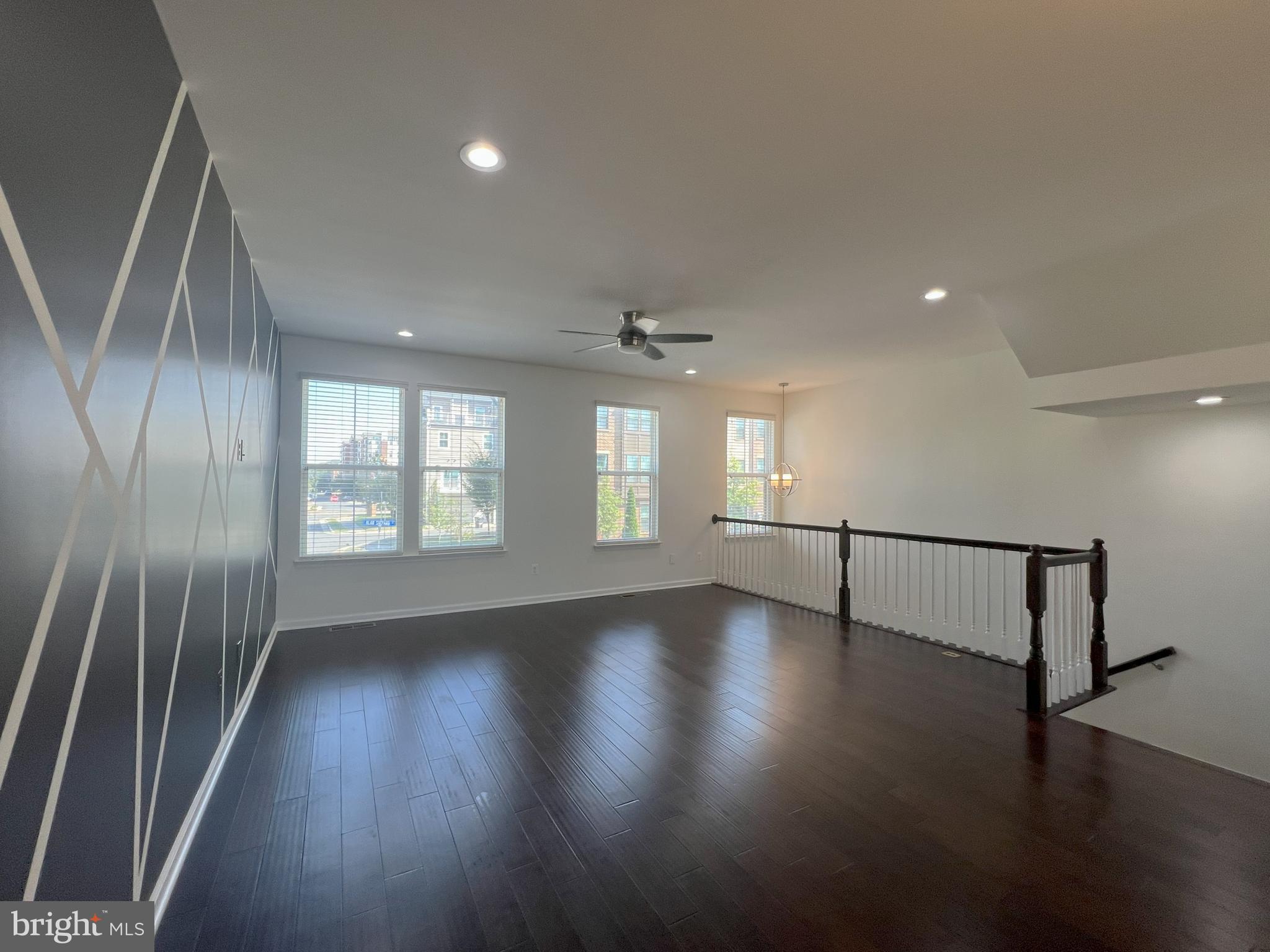 3092 Alan Shepard Street Herndon, VA 20171 - Photo 4 of 45 an empty room with wooden floor and windows