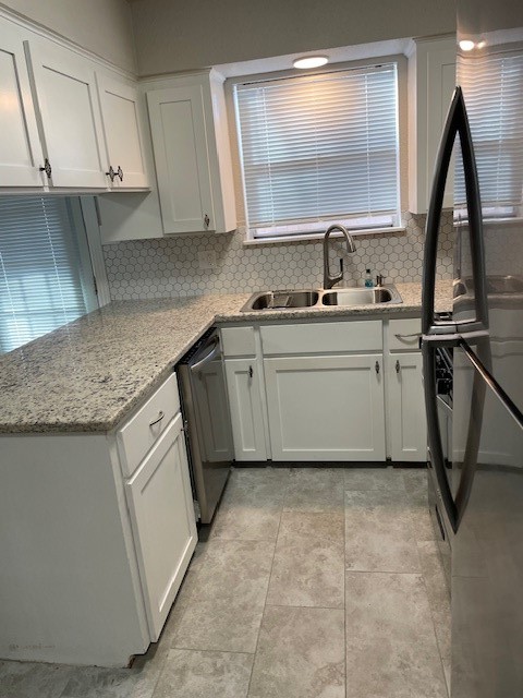407 West Semands Street Conroe, TX 77301 - Photo 15 of 28 a kitchen with a sink window and cabinets