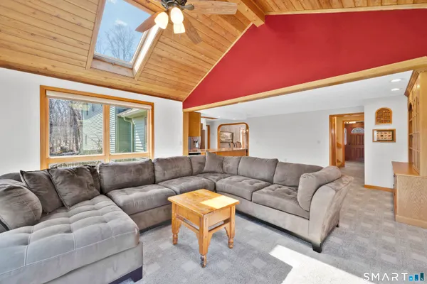 an empty room with a fireplace and cabinet