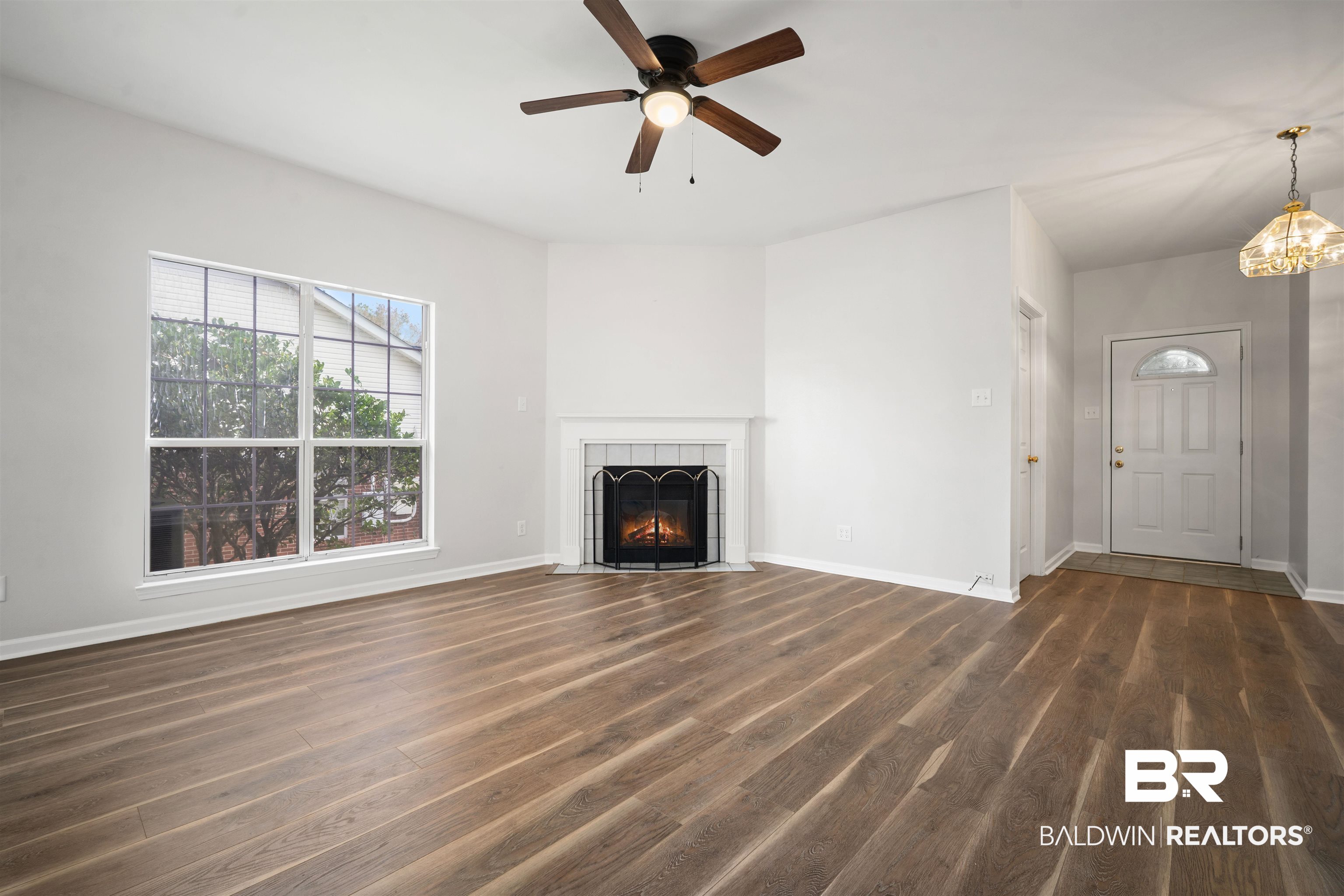 250 North Spring Lake Drive Mobile, AL 36695 - Photo 17 of 29 Unfurnished living room featuringwood finished floors, gas logs fireplace, and ceiling fan