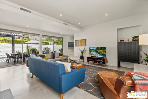 a dining room with wooden floor and stainless steel appliances