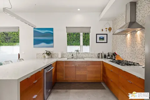 a kitchen with a sink and stainless steel appliances
