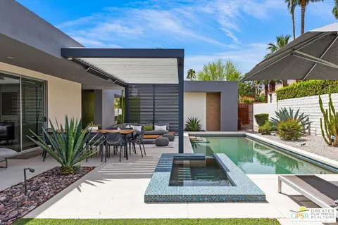 a view of a house with backyard outdoor seating area