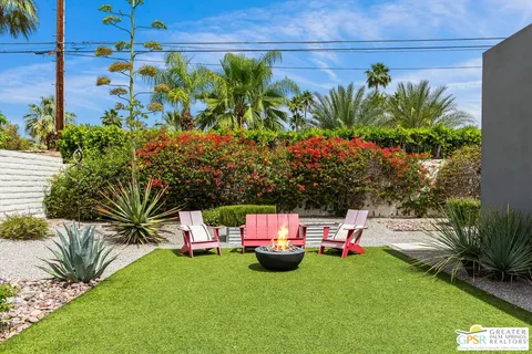 a view of a house with swimming pool and sitting area