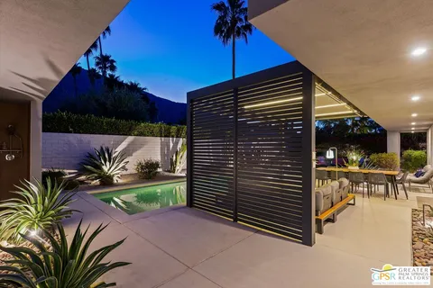a view of a patio with table and chairs and potted plants