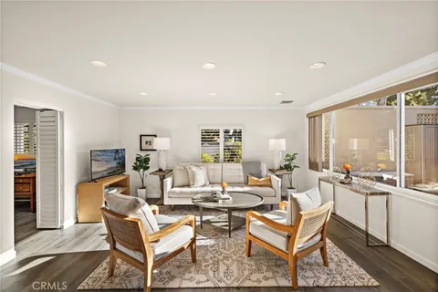 a living room with fireplace furniture and a large window