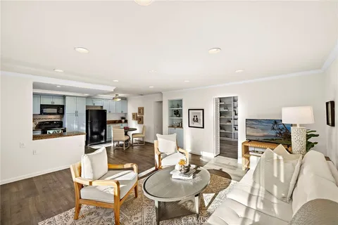 a living room with furniture and kitchen view