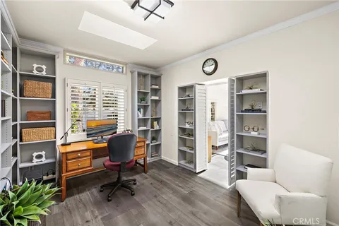 a view of a livingroom with workspace and a window