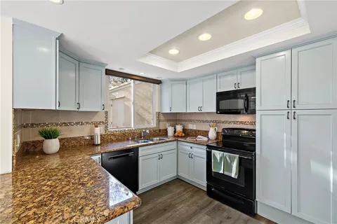 a kitchen with a sink stove and microwave