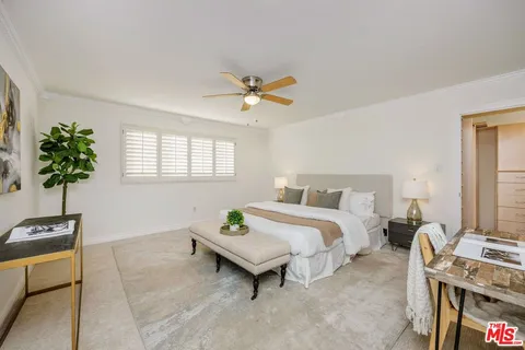 a bed room with a bed and a potted plant