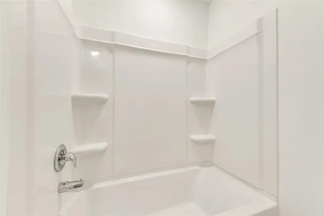 a bathroom with a bathtub and shower