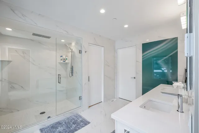 a bathroom with a shower and a sink