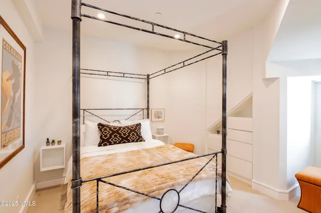 a bedroom with a bed and a glass walk in closet