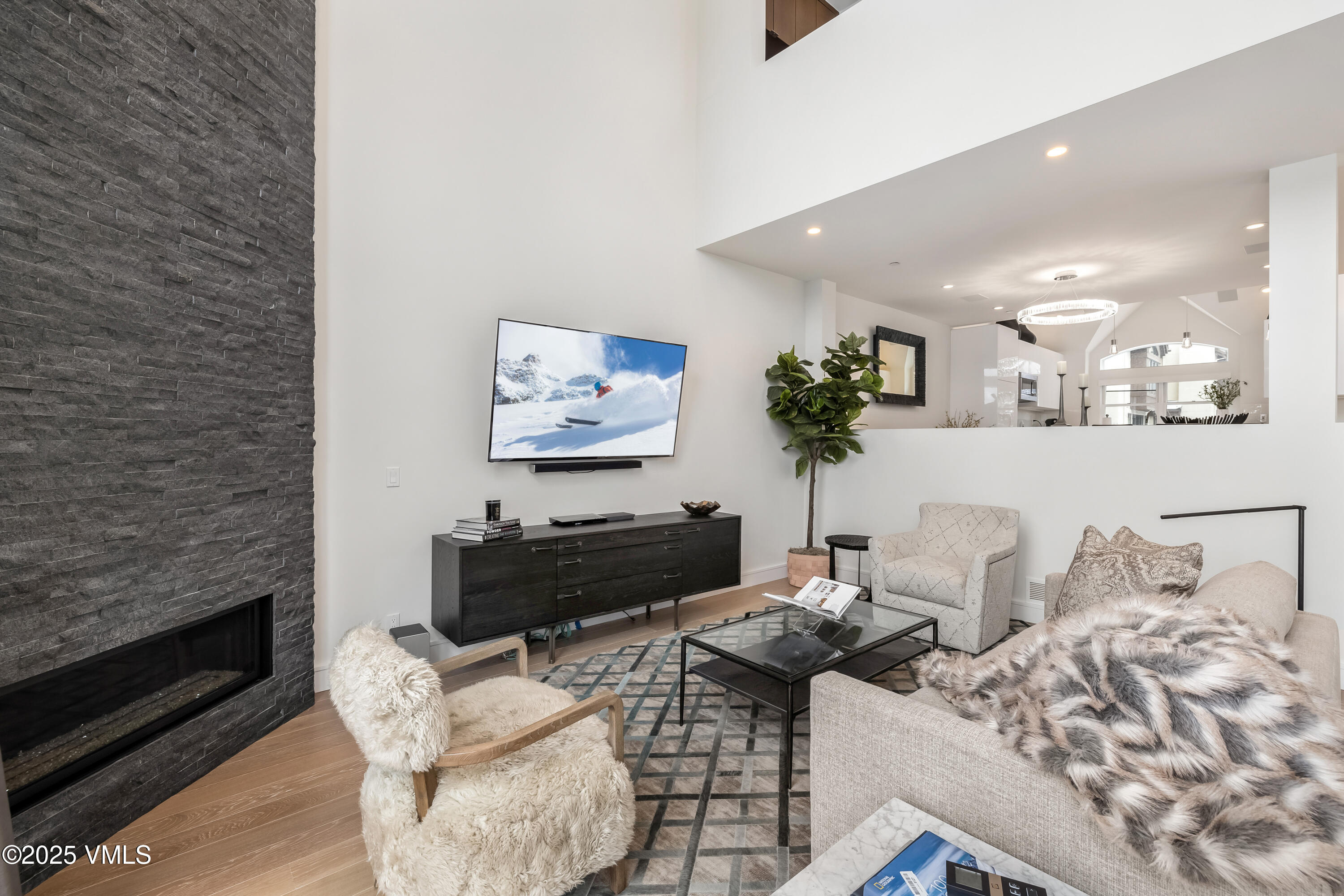 83 Offerson Road, Unit 1 Beaver Creek, CO 81620 - Photo 3 of 27 a living room with furniture wooden floor and a fireplace