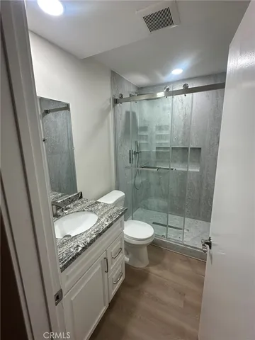 a bathroom with a toilet and a shower