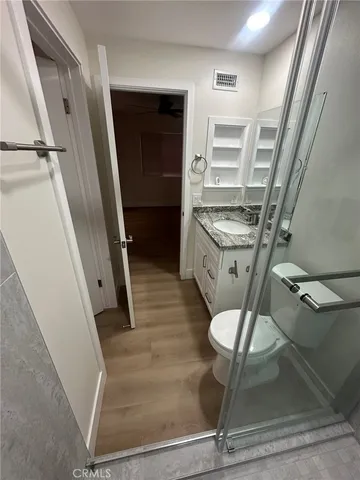 a view of empty room with wooden floor and fireplace