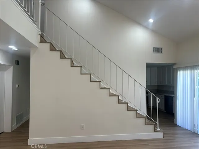 a view of a hallway with wooden floor