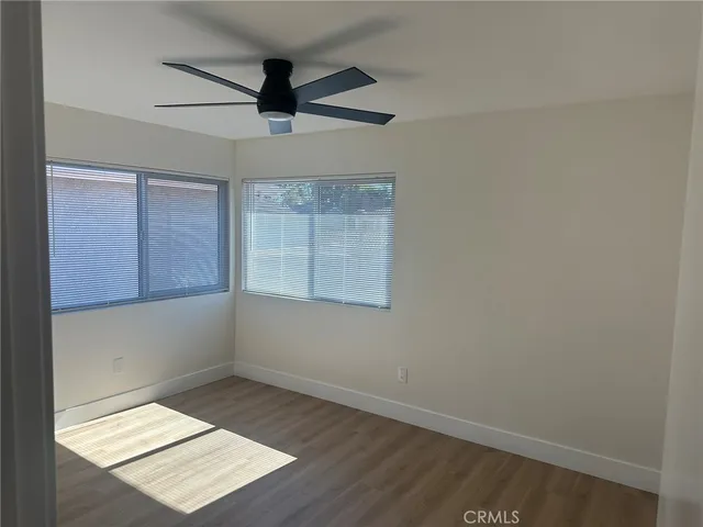 a bathroom with a granite countertop sink a toilet a mirror and shower