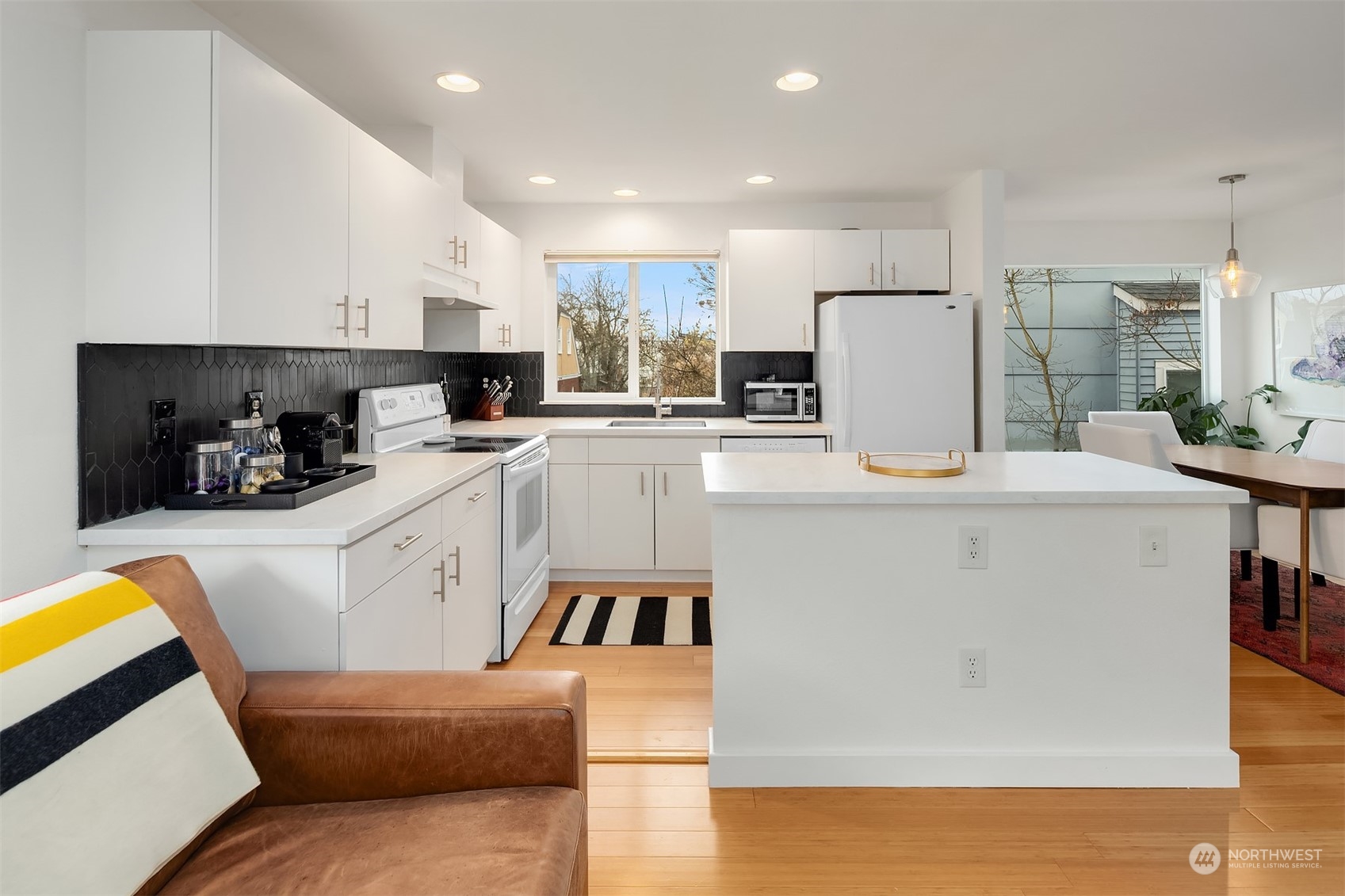 6528 34th Avenue Southwest Seattle, WA 98126 - Photo 2 of 13 a kitchen with stainless steel appliances granite countertop a refrigerator a stove a sink dishwasher and a refrigerator with wooden floor