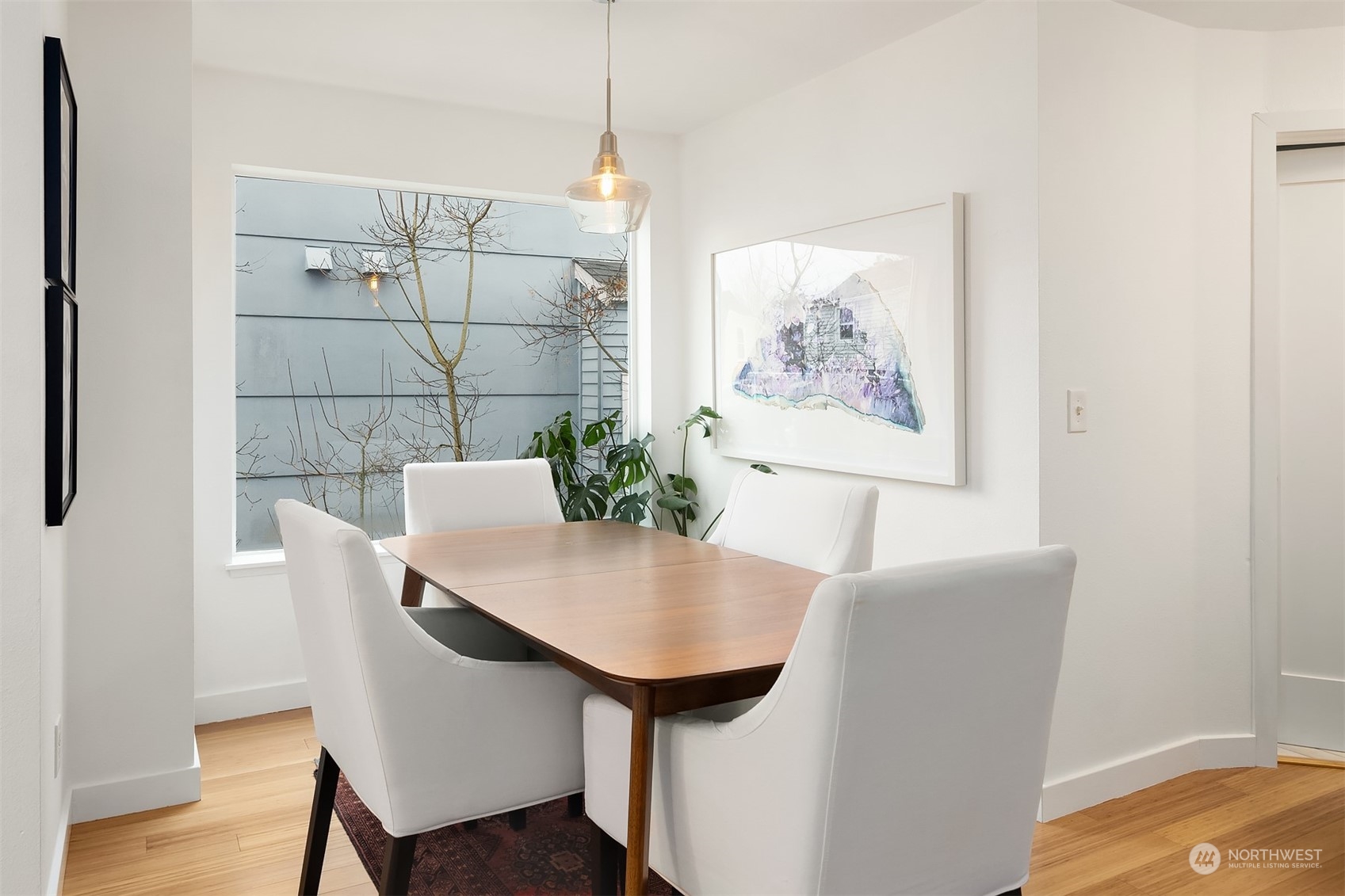 6528 34th Avenue Southwest Seattle, WA 98126 - Photo 6 of 13 a view of a dining room with furniture and wooden floor