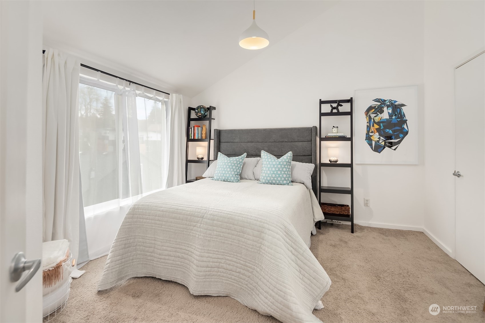6528 34th Avenue Southwest Seattle, WA 98126 - Photo 7 of 13 a bedroom with a bed and painting on the wall