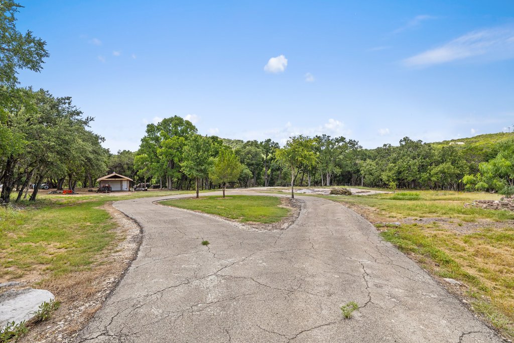 23644 Nameless Road Leander, TX 78641 - Photo 39 of 40 A private, meandering driveway welcomes you to this secluded wooded property with an outbuilding.