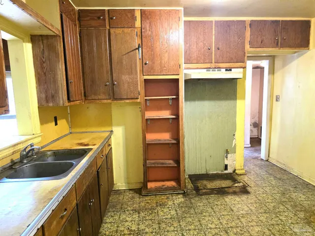 a kitchen with a sink and a refrigerator